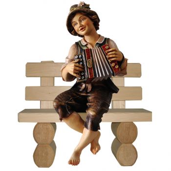Chlapec s akordeónom na lavičke