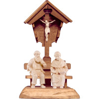 Grandparents sitting under field cross